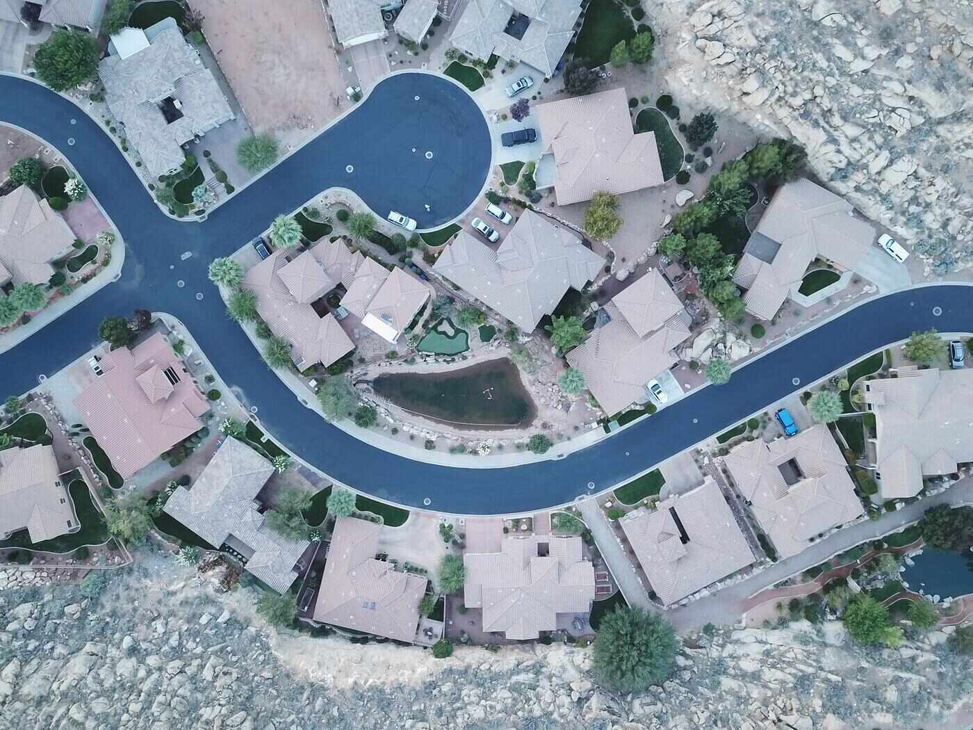 Aerial view of a Valley subdivision street of tile-roofed houses with gravel yards