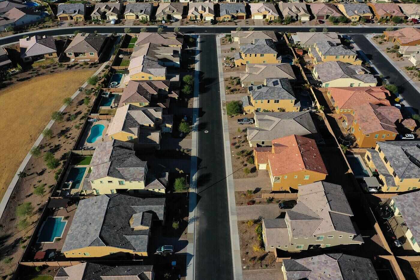 Aerial view of a newer Valley subdivision of tile-roofed houses with pools