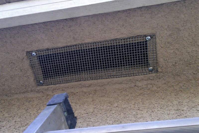 Quarter-inch galvanized hardware cloth fitted behind a soffit vent opening and screwed to the frame