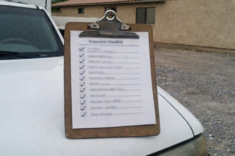 An inspection checklist on a clipboard on a truck hood, the document the quote is written from