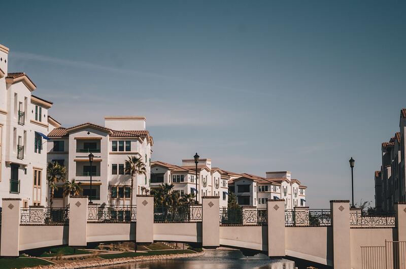 A canal and bridge running past a residential district in Chandler
