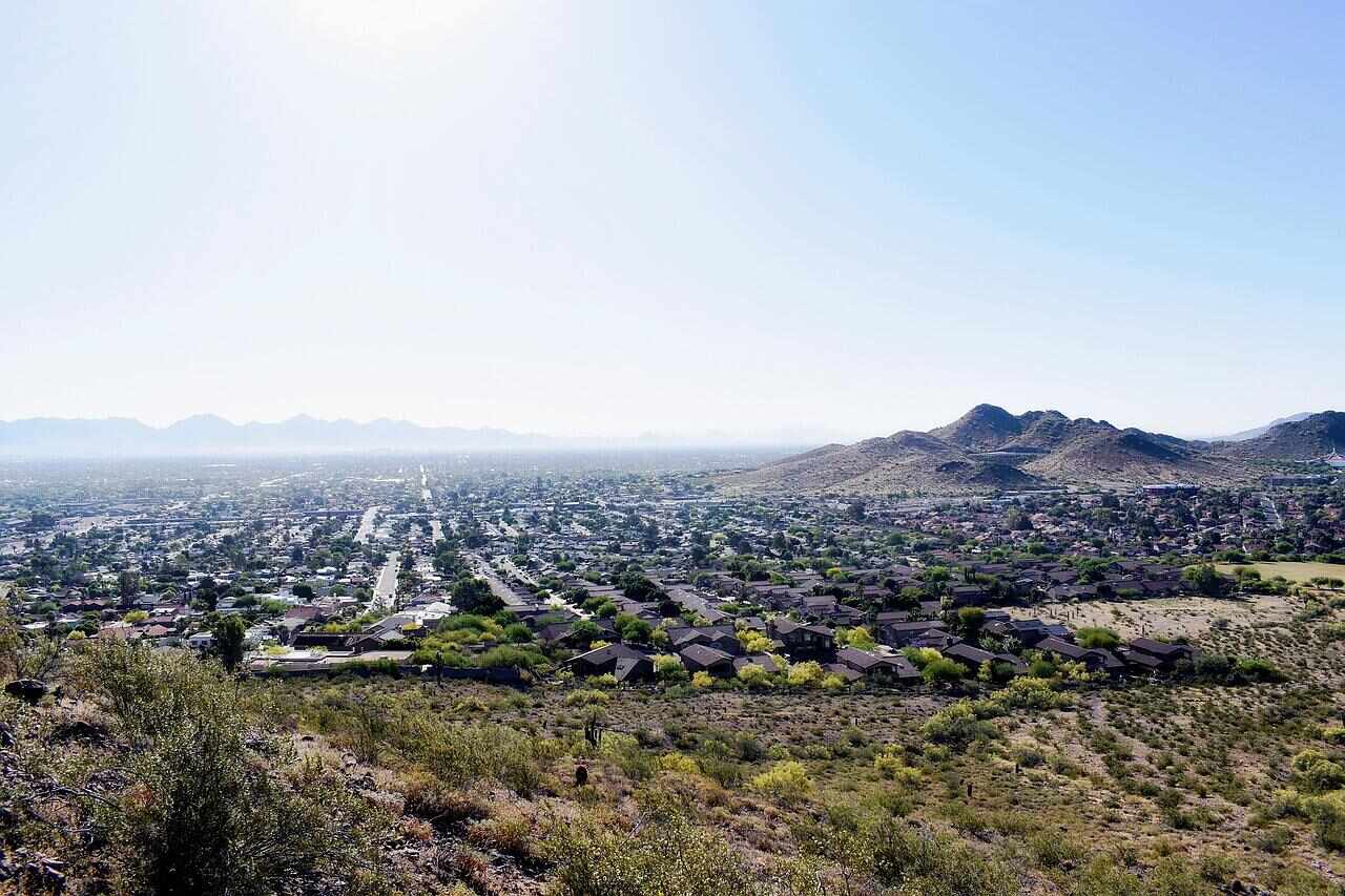 Houses spreading out below desert hills on the edge of the Phoenix valley